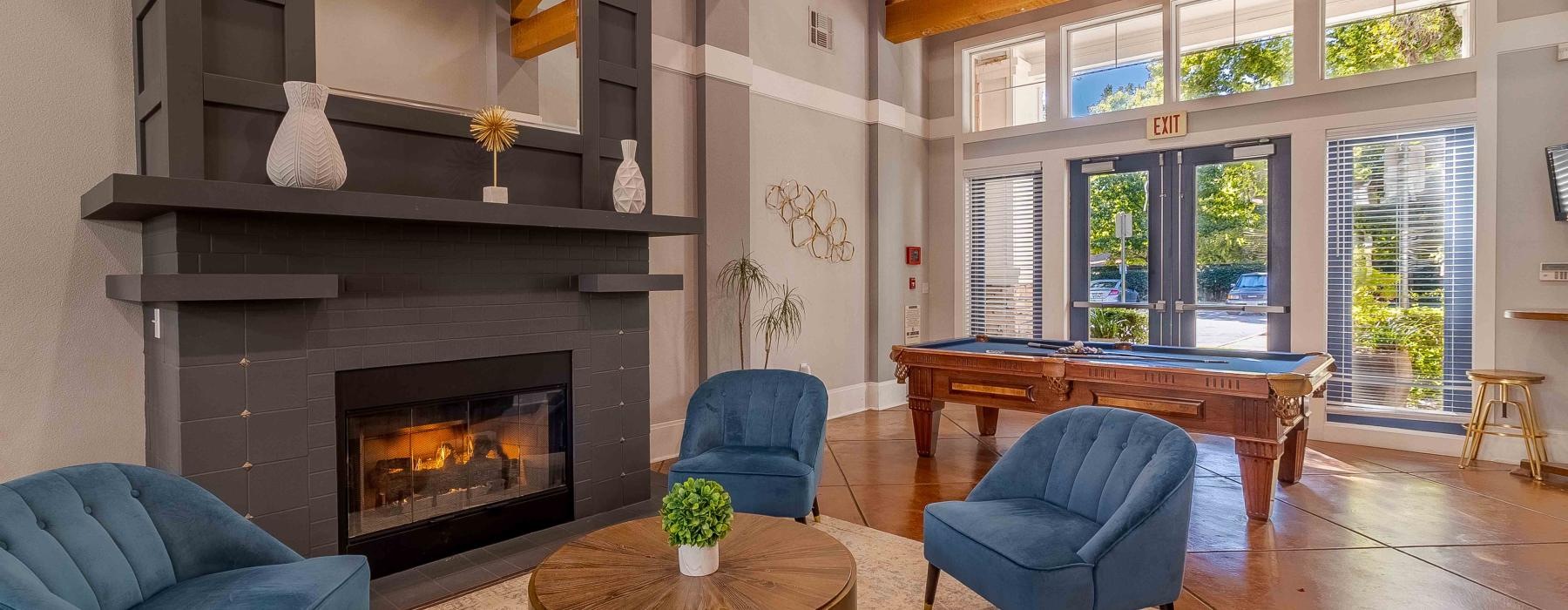 a room with a fireplace and chairs