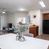a kitchen with wooden cabinets and chairs