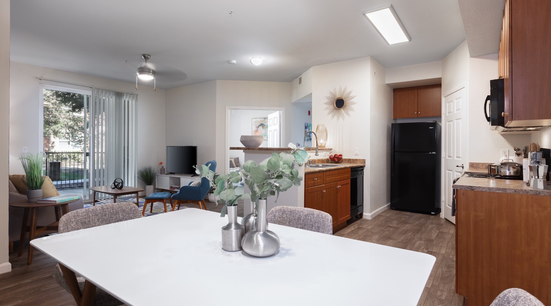 a kitchen with wooden cabinets and chairs